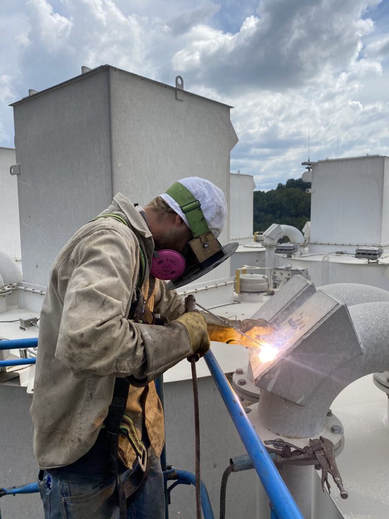 welder repairing vent